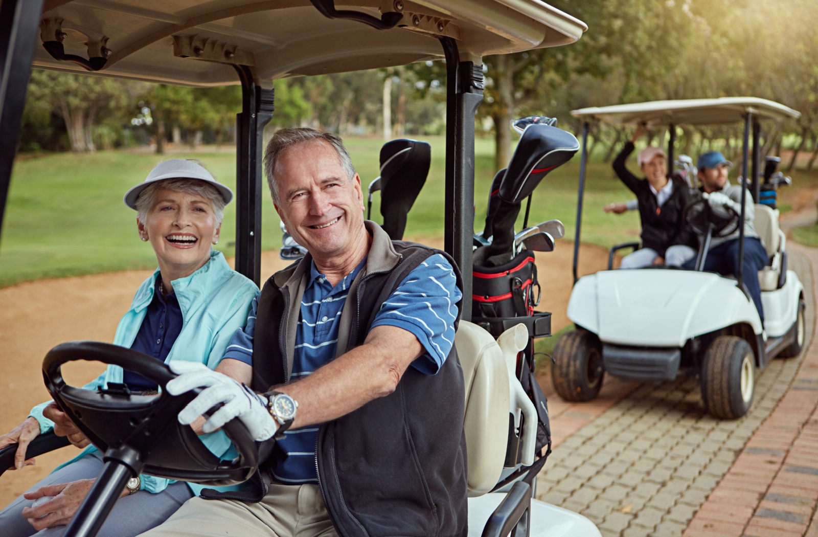 A group of seniors enjoy a day of golf and getting around easily in their golf carts.