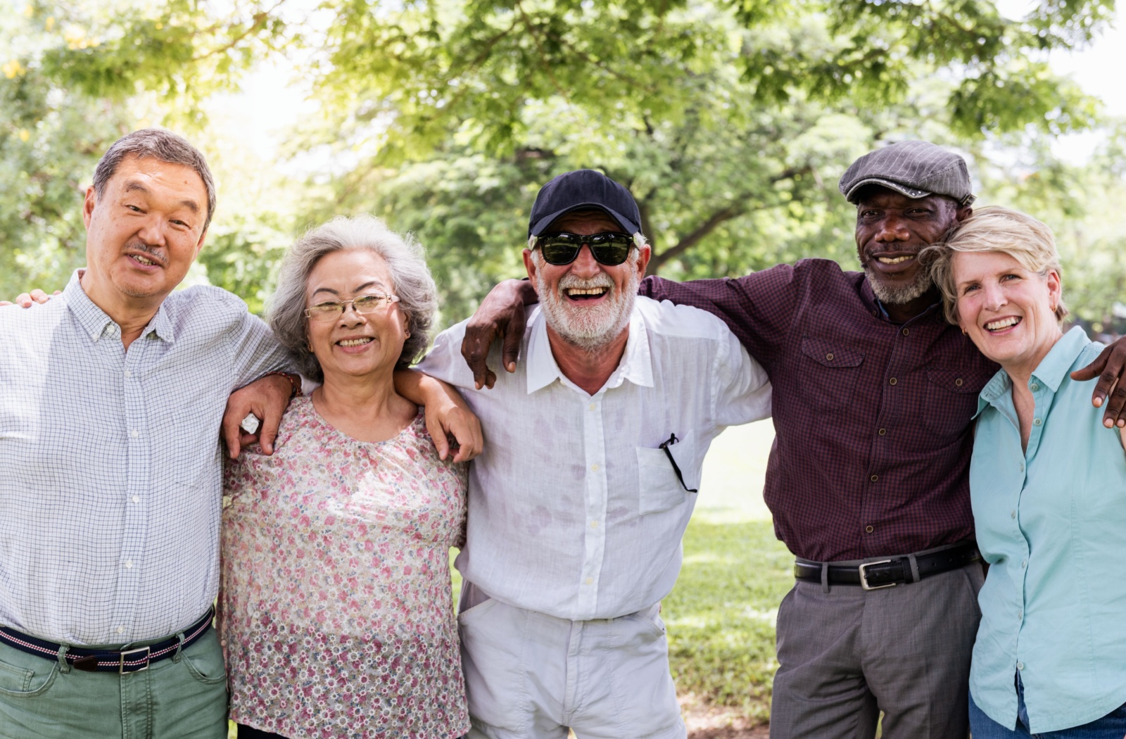 A group of people who live together in an assisted living community smile for a photo together.